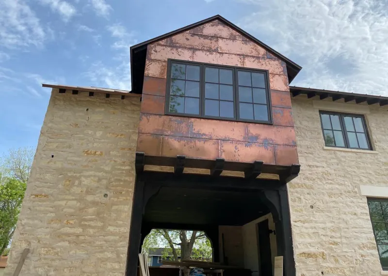 Copper metal panel facade on a stone building for Roof Repair in Abilene